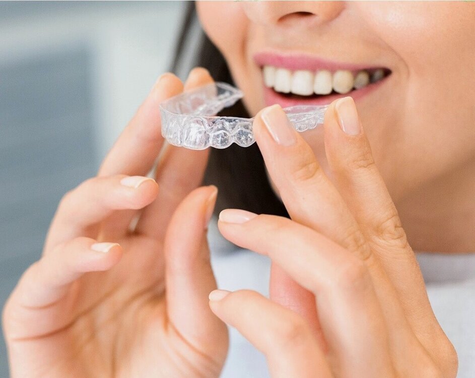 woman holding an Invisalign